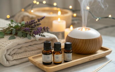 Ätherische Öle für die Aromatherapie auf einem Holztablett mit Diffuser und Lavendel im Hintergrund.